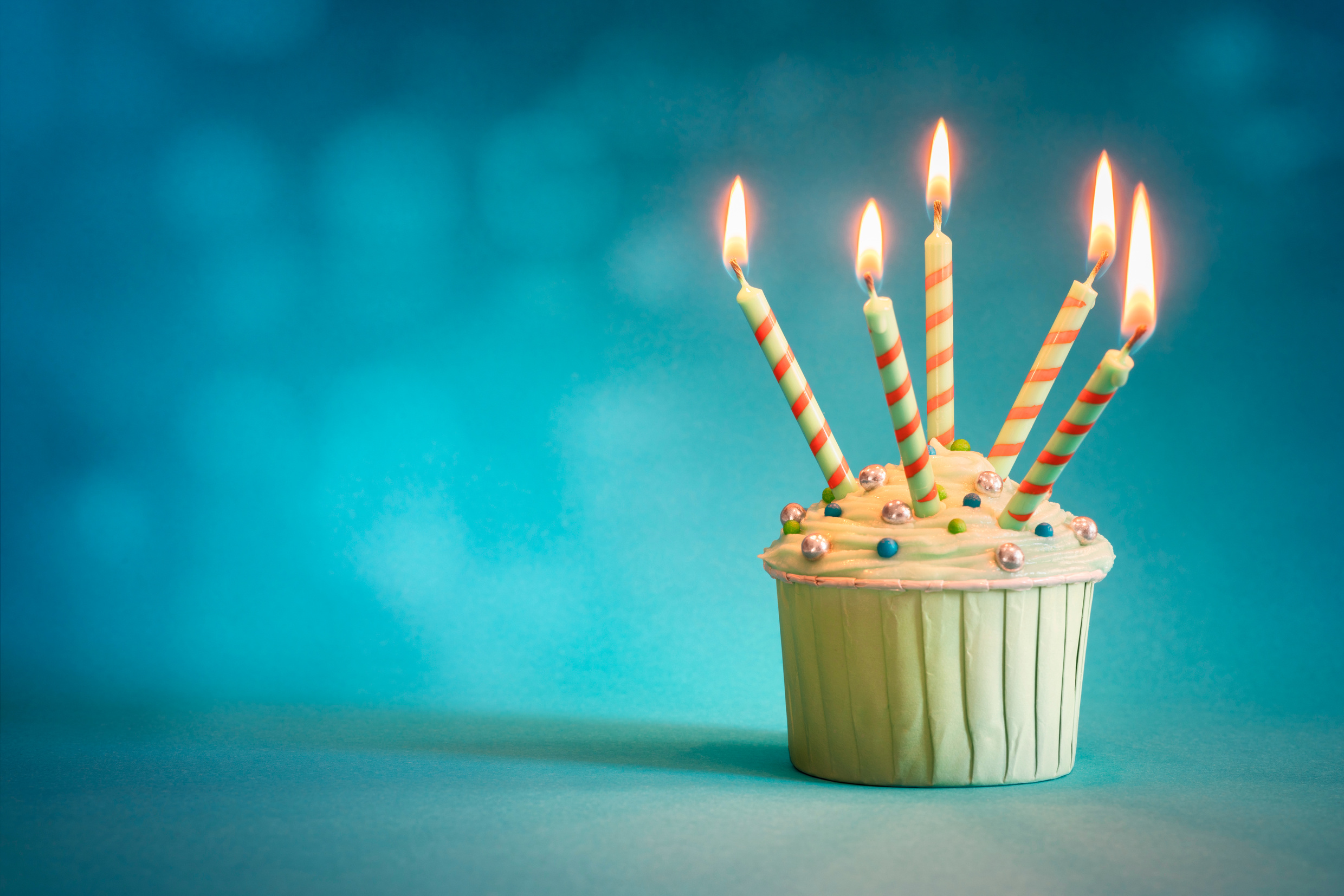 Birthday cupcake on blue background